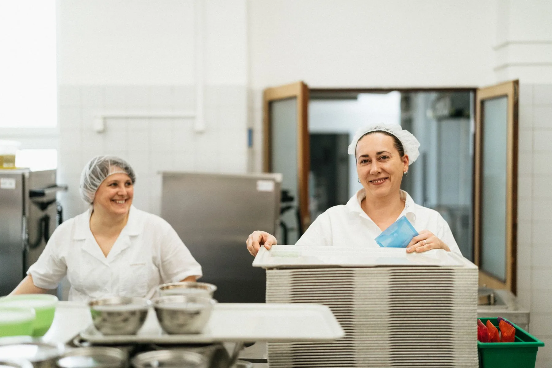 Two employees working together on production and planning in a professional kitchen