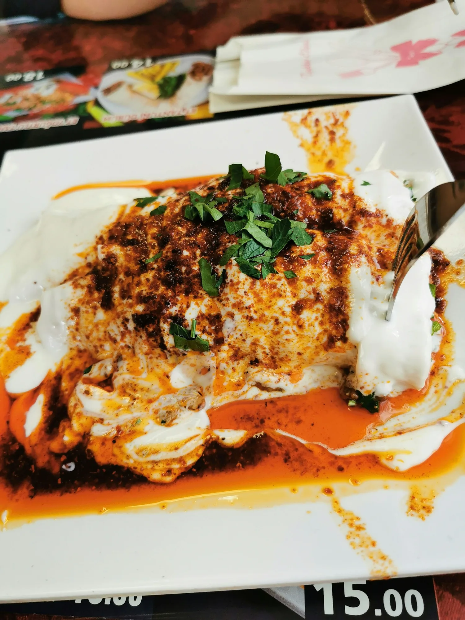 Tantuni prepared on a hot metal pan with lavaş, lemon, sumac and parsley