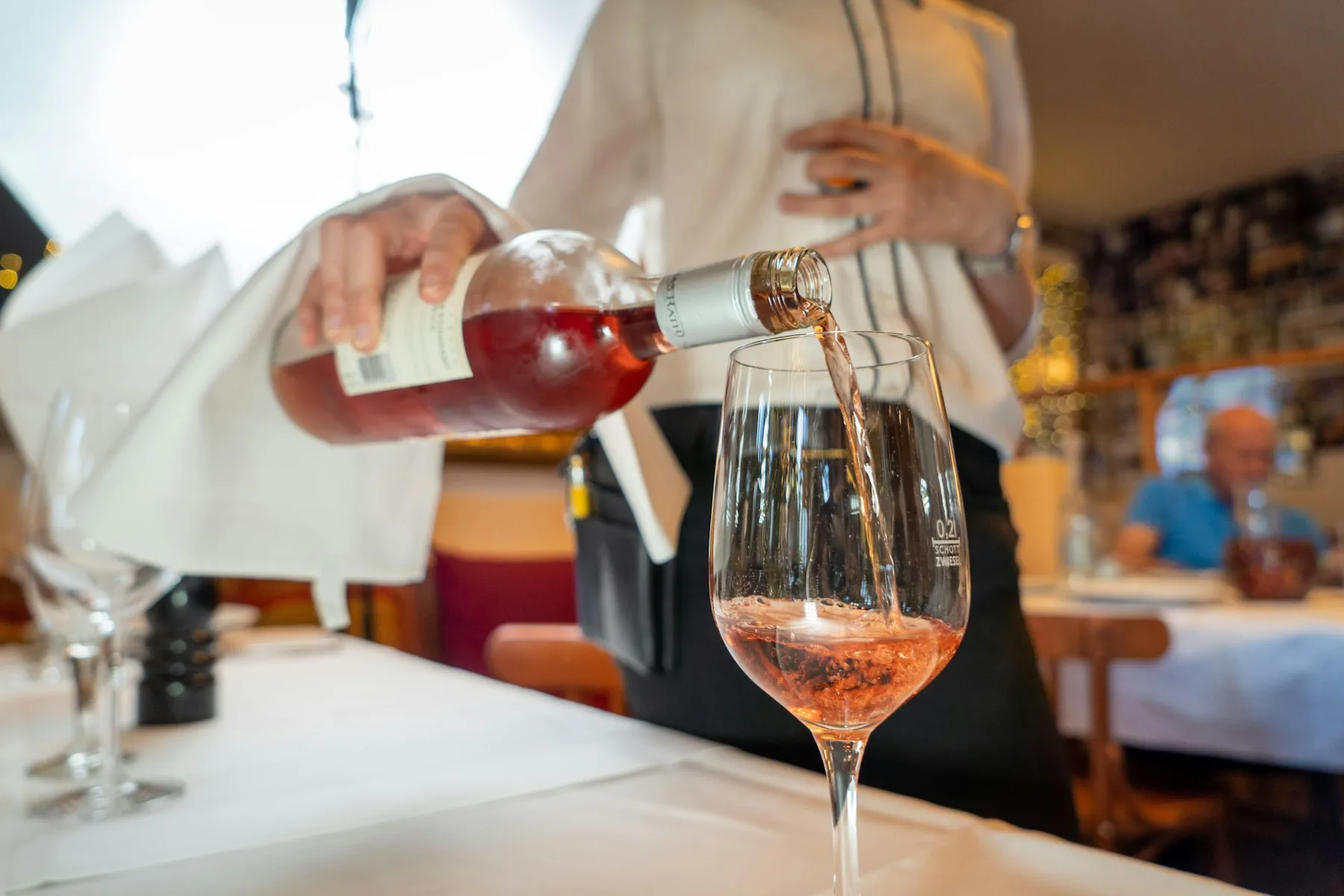 Waiter naturally recommending dessert and digestifs to restaurant customers