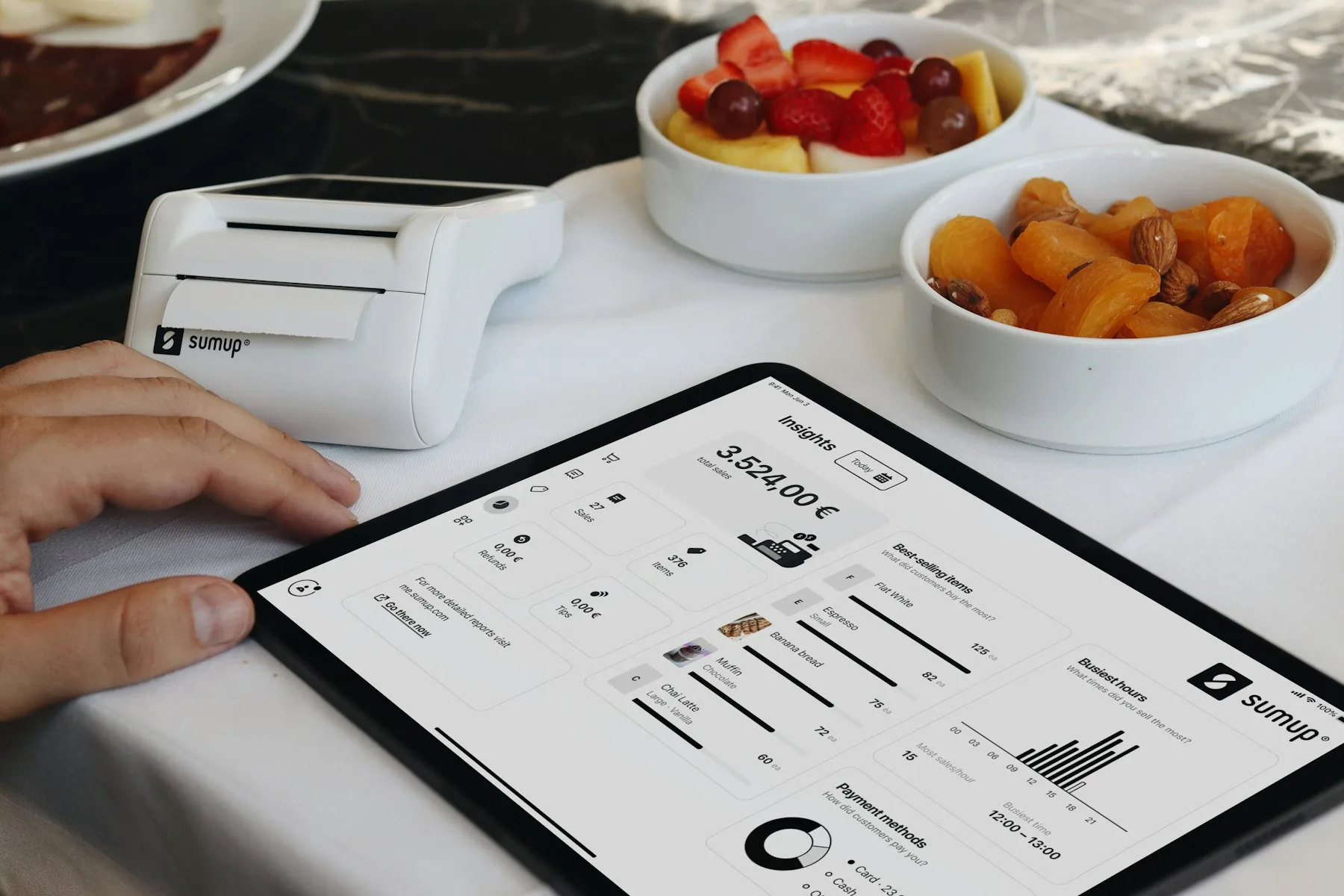 Restaurant manager testing a POS system, payment terminal and kitchen display before service