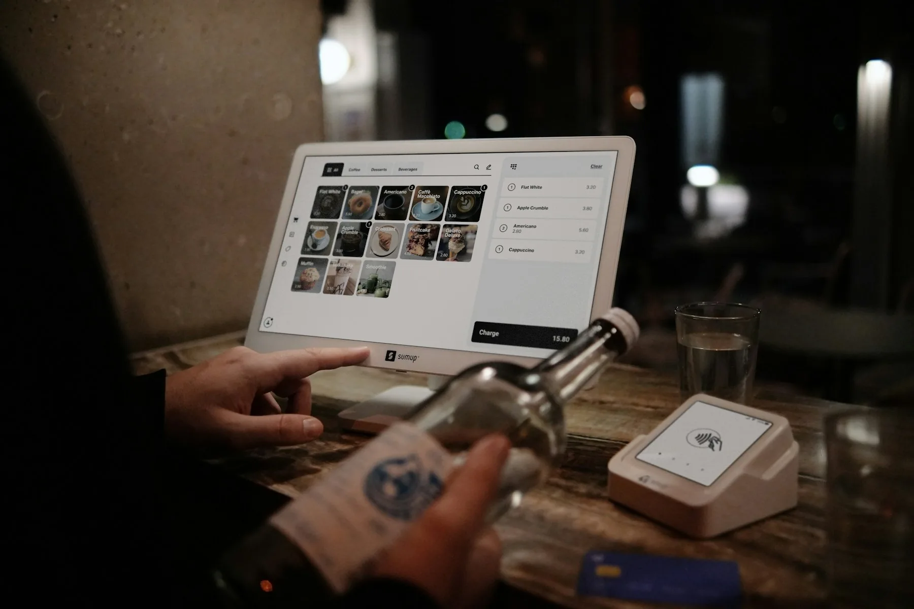 Restaurant manager working digitally on a computer in a modern bar